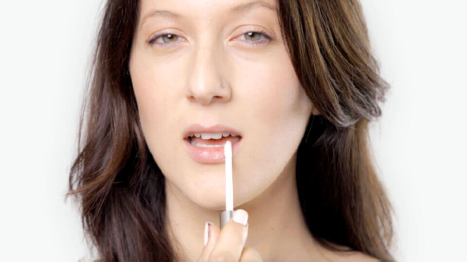 woman applying Sublime Lips