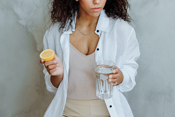woman holds lemon water