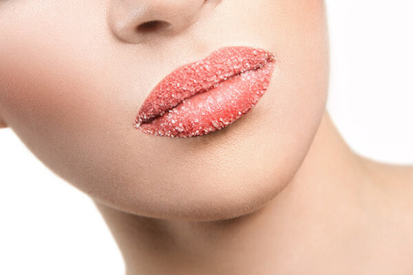 woman exfoliating lips